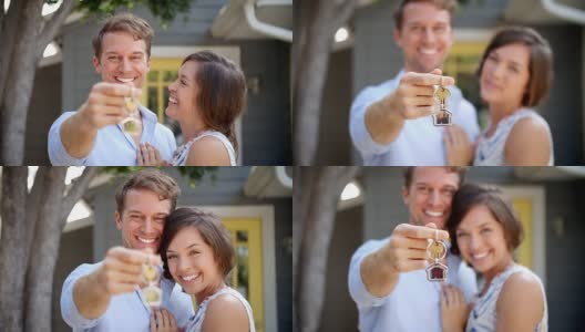 新婚夫妇拿着钥匙站在新家外面的肖像高清在线视频素材下载
