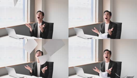 一位亚洲华裔年轻白领坐在办公室的椅子上，把文件扔向空中，心情沮丧，情绪紧张高清在线视频素材下载