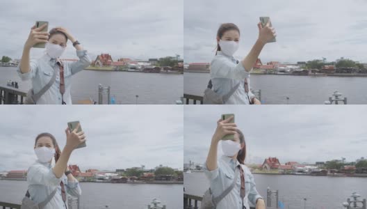 亚洲成年女子在泰国当地旅游时自拍。有魅力的女性在当地旅游时，用智能手机给社交媒体上的朋友打电话。独行侠的概念。高清在线视频素材下载