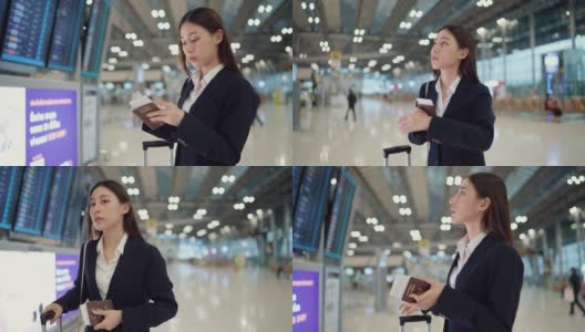 聪明的女人拿着她的行李在机场寻找货币兑换柜台高清在线视频素材下载