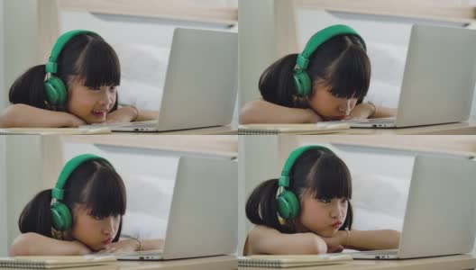 亚洲小女孩在家里学习在线课程。高清在线视频素材下载