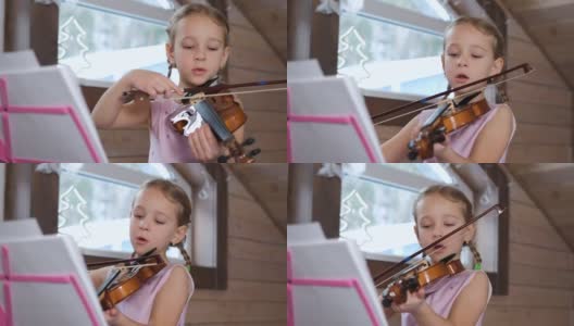 孩子在家里拉小提琴和唱歌高清在线视频素材下载