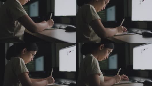 一名年轻女性晚上在家庭办公室用平板电脑写文章，滚动新闻推送，为她的工作计划搜索在线信息数据。高清在线视频素材下载
