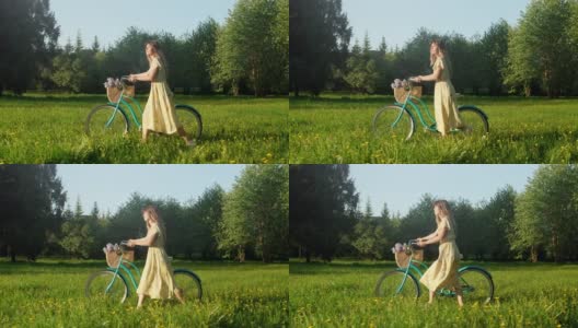 快乐的年轻女子走在自行车与花篮在乡村道路上在夏天的日出。美丽的女人在地上的道路绿草地有乐趣和享受生活高清在线视频素材下载
