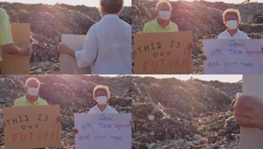 描绘一对亚洲老年夫妇站在来自亚洲垃圾填埋场的巨大垃圾堆上，手持环保运动人士为大自然而战的海报。志愿服务、慈善、清洁、退休、老年人及生态理念高清在线视频素材下载