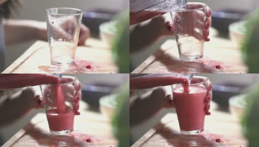 特写的水果奶昔倒进玻璃杯高清在线视频素材下载
