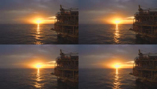 海上油气平台，中央处理平台在日落时产生原料气和凝析油或原油，然后将天然气输送至陆上炼油厂高清在线视频素材下载