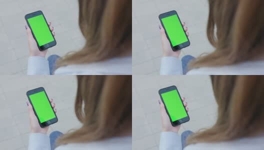 一位女士使用绿屏手机高清在线视频素材下载