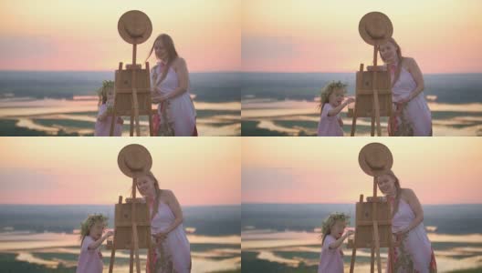 年轻的白人妇女和女儿画自然在夏山日落高清在线视频素材下载