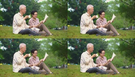 一对亚洲老夫妇在公园看书。花宝贵的时间，永远不要停止学习新东西高清在线视频素材下载