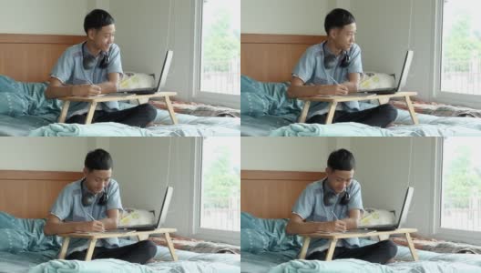十几岁的亚洲男孩学习期间的社交距离在家里高清在线视频素材下载