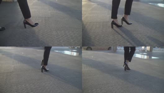 特写镜头:女商人的腿在美丽的阳光下行走高清在线视频素材下载