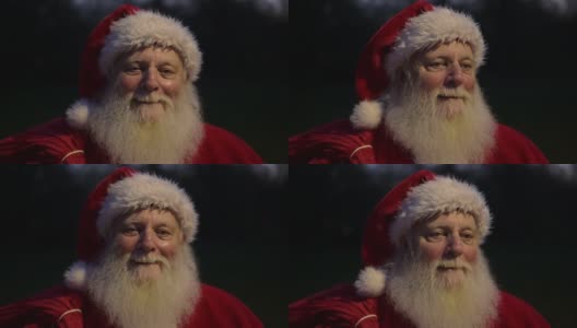 兴高采烈的圣诞老人的头像和一包礼物高清在线视频素材下载