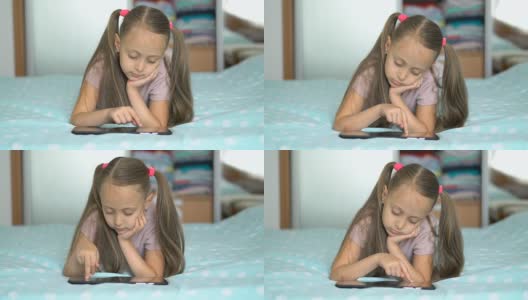 小女生躺在父母的床上玩平板电脑高清在线视频素材下载