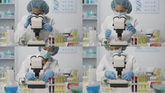 在实验室用显微镜观察微生物样本的医学科学家高清在线视频素材下载