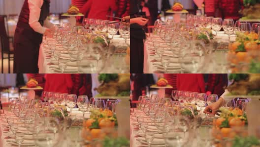 服务员在餐厅宴会桌上安排酒杯，空酒杯放在宴会桌上，新年、圣诞节高清在线视频素材下载