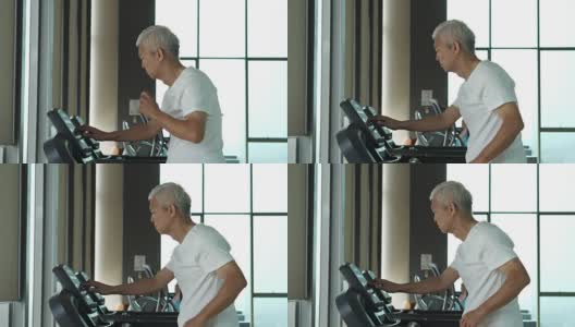 亚洲老年人在健身房的跑步机上跑步，锻炼健康的生活方式高清在线视频素材下载