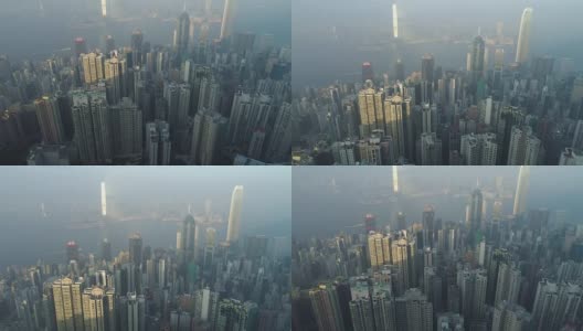 香港天际线及维多利亚港鸟瞰图。无人机向前飞行，摄像头向上倾斜。远景。高清在线视频素材下载
