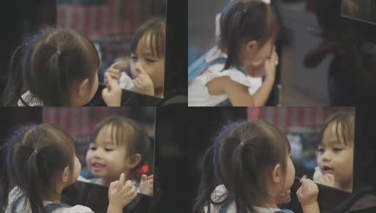 泰国女孩使她的脸幽默的镜子反射高清在线视频素材下载