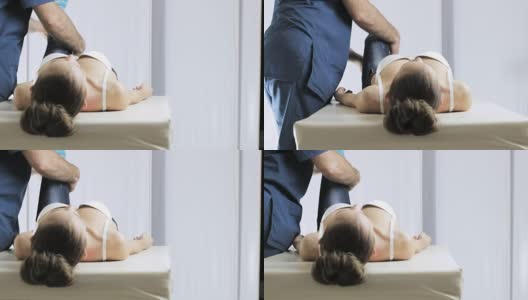 医生手工治疗师检查脚关节，女病人高清在线视频素材下载