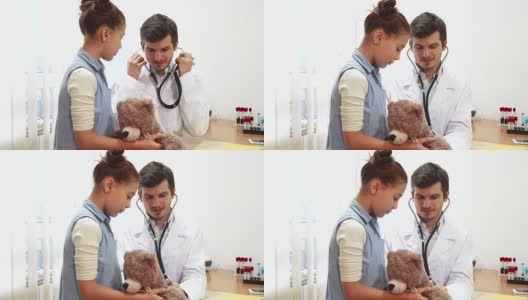 这位好医生正在用听诊器听小女孩的软玩具高清在线视频素材下载