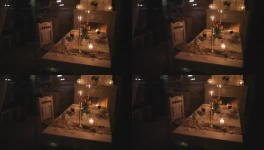 一对恩爱的夫妇在壁炉旁的烛光下进餐高清在线视频素材下载