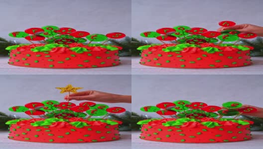 用球装饰圣诞蛋糕，上面刻着“德国节日快乐”的字样。一只女性的手把装饰放在蛋糕上。高清在线视频素材下载