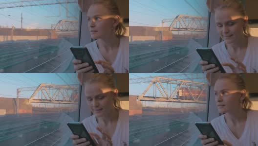 在俄罗斯圣彼得堡，火车上坐着年轻的女孩，看着窗外高清在线视频素材下载
