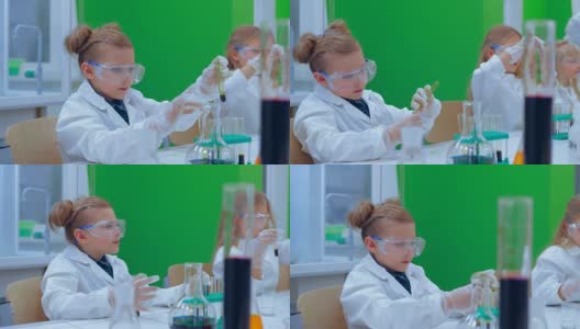 一组孩子在化学课上做实验。化学课上的孩子们高清在线视频素材下载