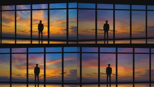 在日出的背景下，站在窗边的男人。时间流逝高清在线视频素材下载