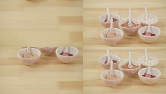 镜头向上移动，显示出木桌上一个陶瓷碗的特写，碗里放着不同药草的粉末。高清在线视频素材下载