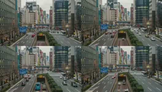 在日本东京新桥车站，一群不明身份的人在人行道上行走，路上有车流和隧道。日本霓虹街文化与购物概念高清在线视频素材下载
