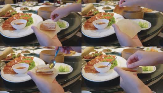 亚洲人在吃北京烤鸭(中国菜)。高清在线视频素材下载