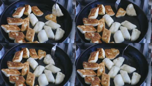 用生面团在油锅里做成的百吉饼，土耳其式早餐油面包的准备，高清在线视频素材下载