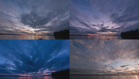 在一个夏夜，天空中浮云飞舞，船和山的剪影高清在线视频素材下载