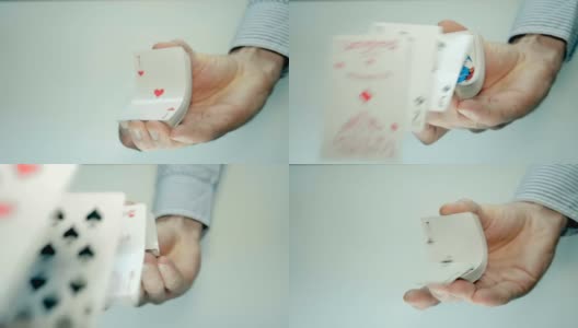 这只手握紧一副扑克牌，它们就会弯曲向前飞高清在线视频素材下载
