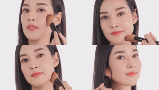 美丽的亚洲女人化妆她的脸在工作室。高清在线视频素材下载