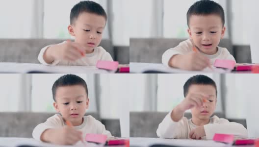 亚洲男孩做家庭作业，教育-孩子在餐桌上学习，家庭学校。高清在线视频素材下载