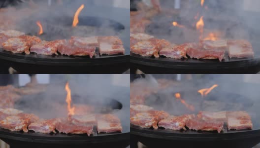 慢镜头:在火盆上用炽热的火焰烹煮肉排的过程-特写高清在线视频素材下载