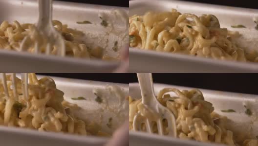 开胃的中国面条在一个塑料容器与塑料叉子，特写，快餐的概念高清在线视频素材下载