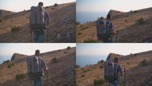 下面是运动员爬山徒步旅行背包徒步旅行的照片。运动的男人走高清在线视频素材下载