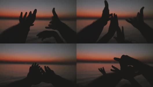 手在夕阳的天空下跳舞。海景高清在线视频素材下载