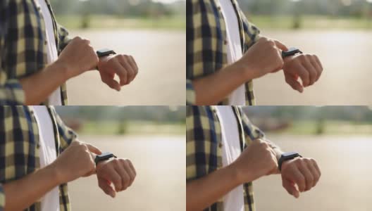 男性手在户外使用可穿戴智能手表的特写。户外男士手上的智能手表。男人的手在触碰智能手表。聪明的手表高清在线视频素材下载