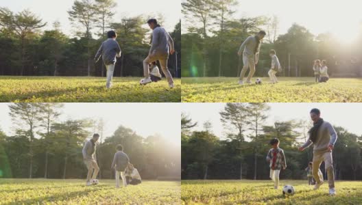 一个亚洲小男孩和爸爸在公园里踢足球高清在线视频素材下载
