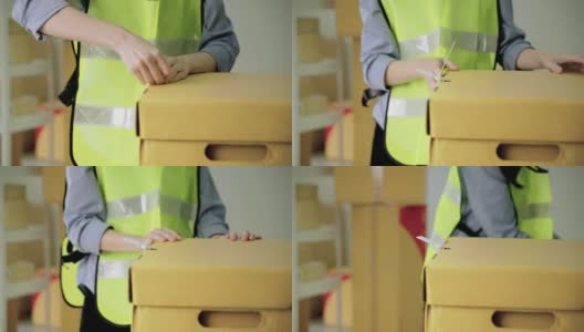 亚洲女工正在用皮带完成包装盒的包装高清在线视频素材下载