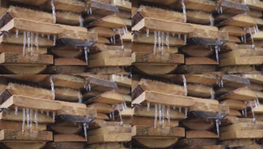 冰柱悬挂在木板上和水滴上。第一次霜冻。气候变化的概念。春天的时间高清在线视频素材下载