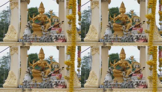 金制的佛教小坛，在花园里供祈祷者使用，上面装饰着鲜花和各种雕像高清在线视频素材下载