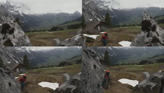 成熟的夫妇骑着山地电动自行车穿越崎岖的山区高清在线视频素材下载