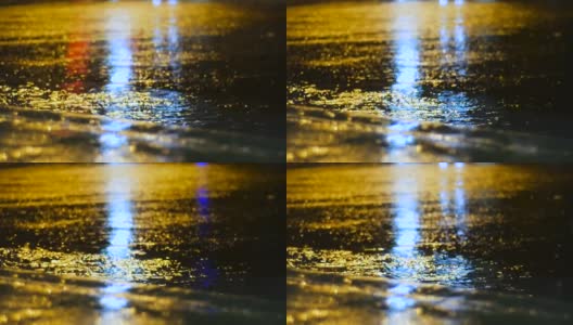 下雨天，夜间交通灯在水面反射高清在线视频素材下载