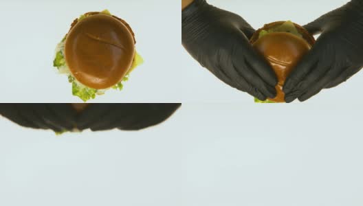 手戴黑手套拿油腻汉堡去品尝，垃圾食品质量把关高清在线视频素材下载